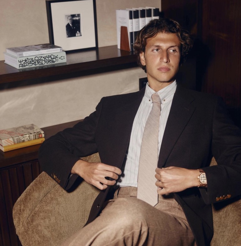 Gstaad Guy seated in a wood-panelled study